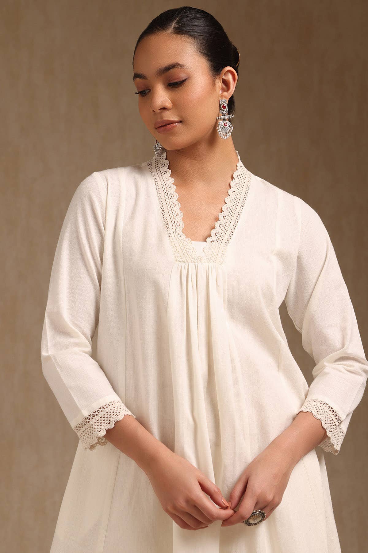 Off White Cotton Solid V-Neck Lace Inserts A-Line Kurta With Front Pleats — image 1
